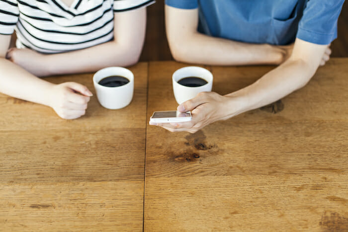 カフェで自分にあったマッチングアプリを選んでいる様子